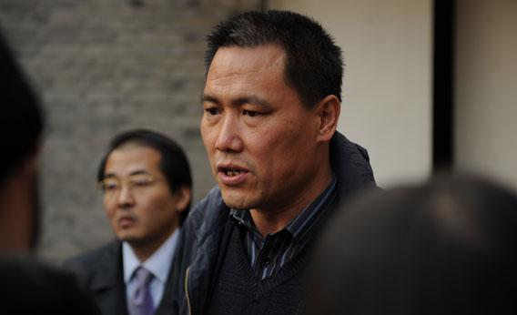 Pu Zhiqiang (center), the lawyer for Chinese artist Ai Weiwei